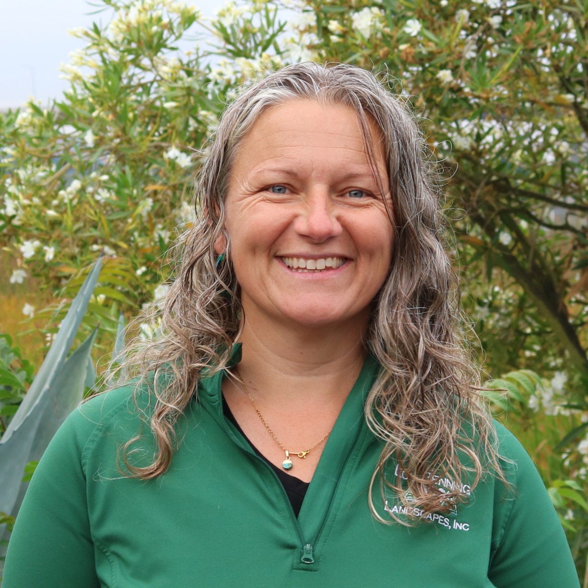 Ali White, Penning Landscapes Maintenance Account Manager, smiling in a garden setting.