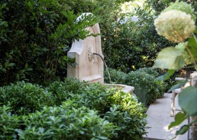 Stone fountain in Penning Landscapes Napa Valley vegetable garden.